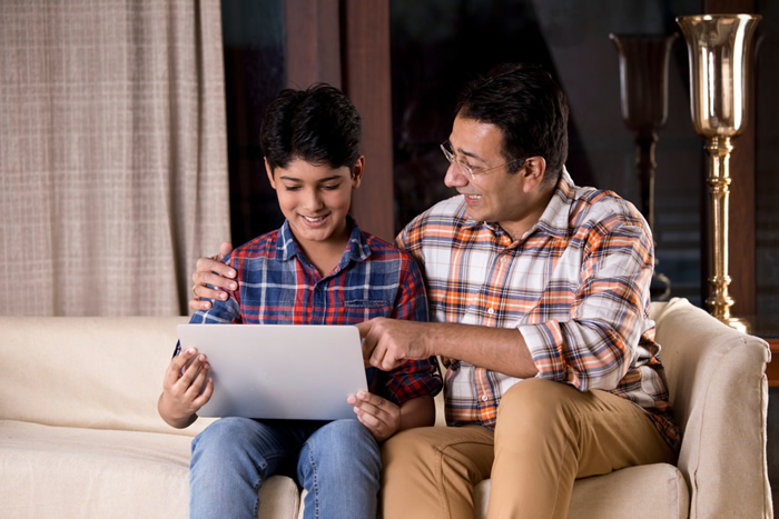 Father helping teen son