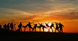 a group of people at sunset